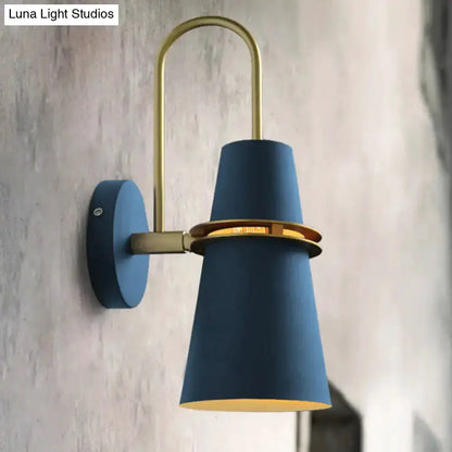 Contemporary blue and gold wall sconce with curved brass arm and flared blue shade on Tampa Home & Garden Store