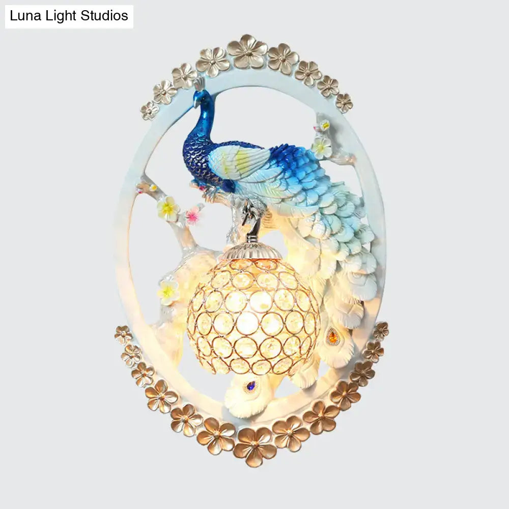 Blue Peacock Wall Sconce by Decorbites, oval frame with gold border and lit lattice lantern on Tampa Home & Garden Store