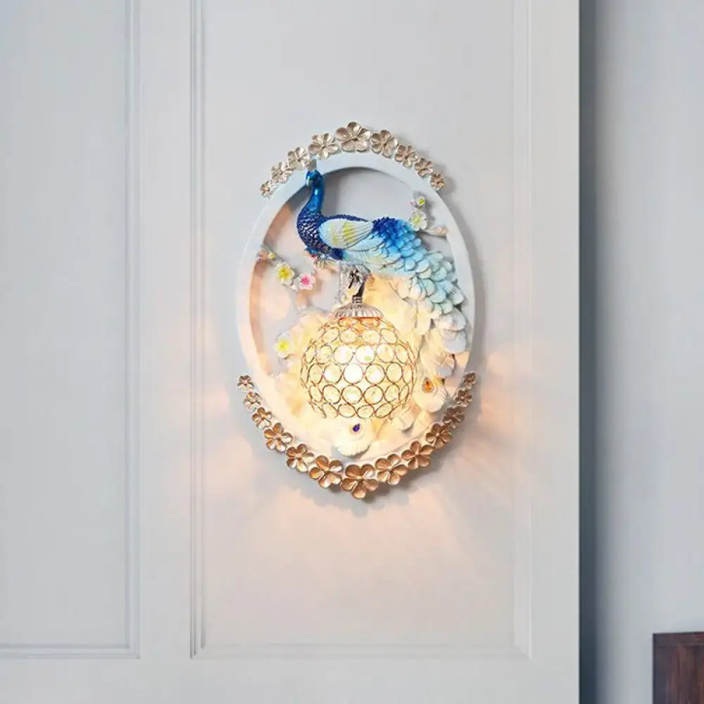 Blue Peacock Wall Sconce by Decorbites, oval frame with blue peacock above lattice lantern on Tampa Home & Garden Store