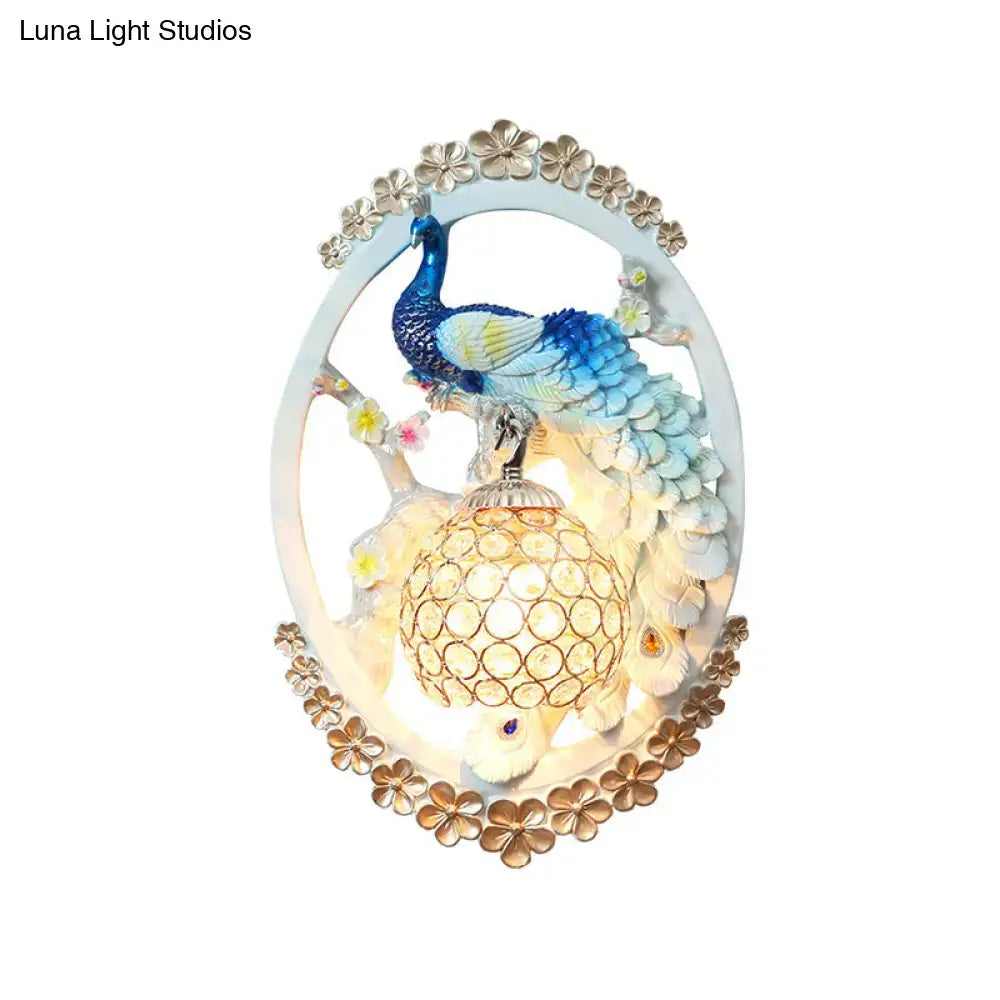 Blue Peacock Wall Sconce with oval frame and lantern glow on Tampa Home & Garden Store