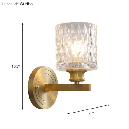 Gold cylindrical glass wall sconce by Decorbites with brass finish and textured crystal shade on Tampa Home & Garden Store