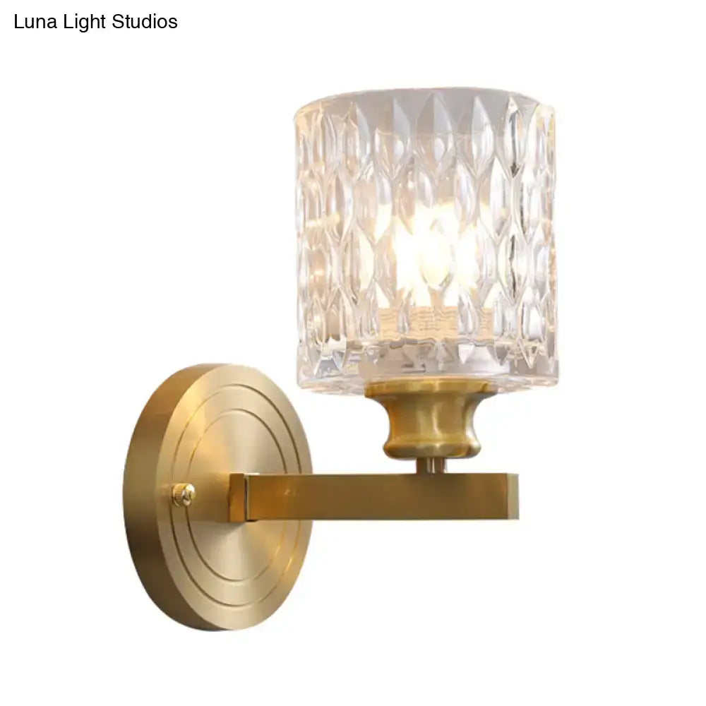 Gold cylindrical glass sconce with textured crystal shade and brass backplate Decorbites on Tampa Home & Garden Store