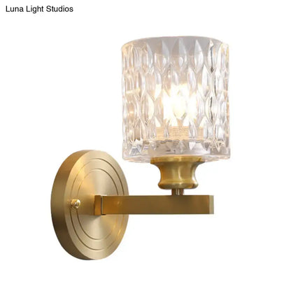 Gold cylindrical glass sconce with textured crystal shade and brass backplate Decorbites on Tampa Home & Garden Store