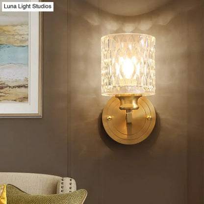 Gold cylindrical glass sconce with crystal shade on brass wall mount by Decorbites on Tampa Home & Garden Store