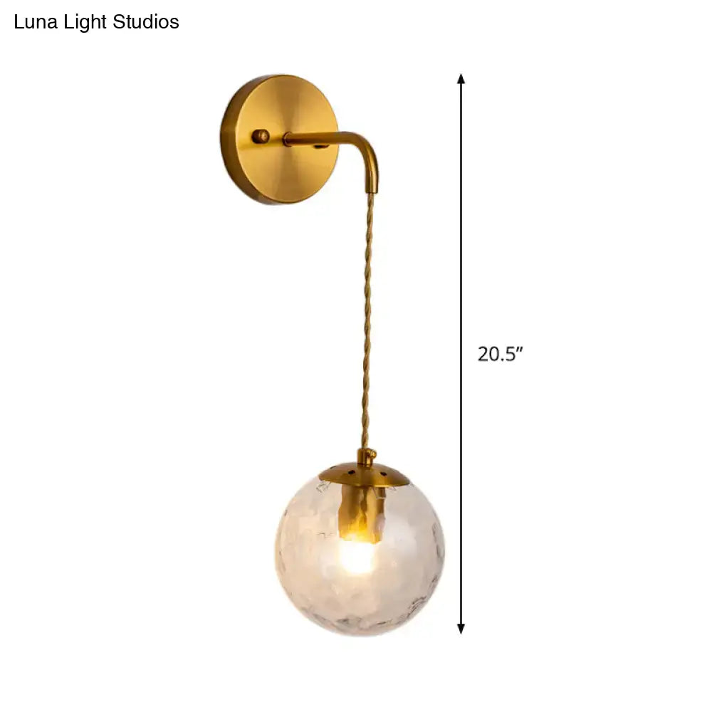 Gold dimpled glass wall lamp with brass wall mount and hanging clear globe by Decorbites on Tampa Home & Garden Store