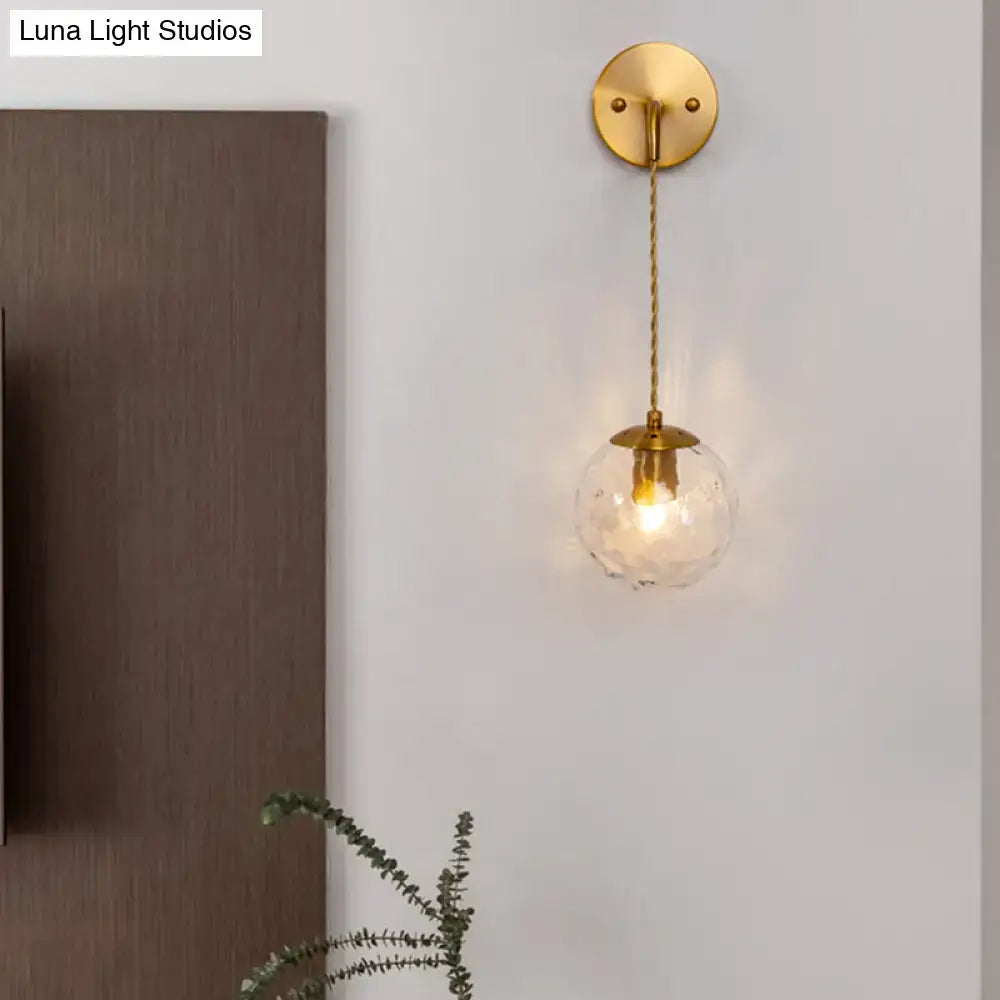 Gold dimpled glass wall lamp with brass canopy and braided rope cord by Decorbites on Tampa Home & Garden Store