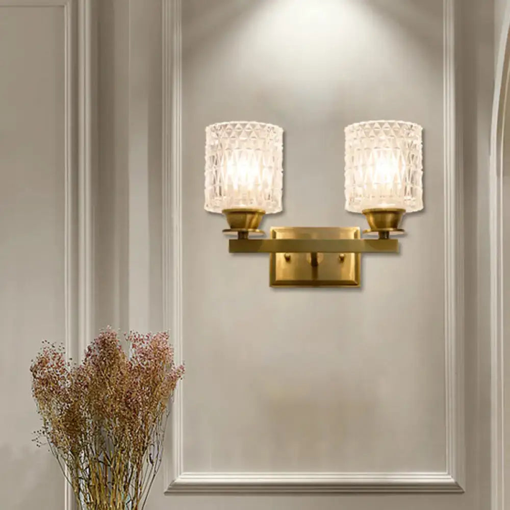 Brass lattice glass wall light with dual candle-style sconces on a gold wall mount on Tampa Home & Garden Store