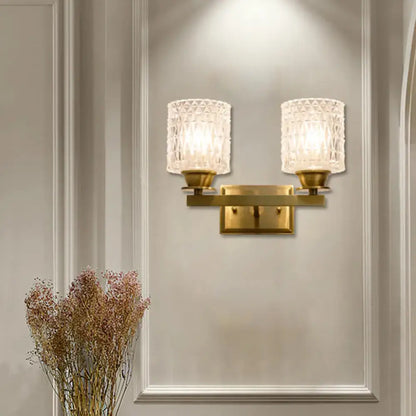 Brass lattice glass wall light with dual candle-style sconces on a gold wall mount on Tampa Home & Garden Store