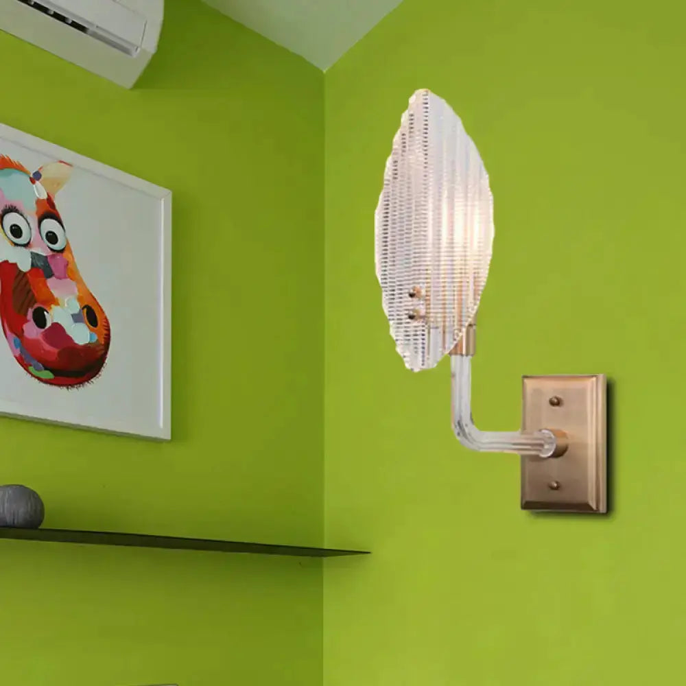 Contemporary brass leaf wall light fixture with glass sconce shade; wall-mounted on Tampa Home & Garden Store