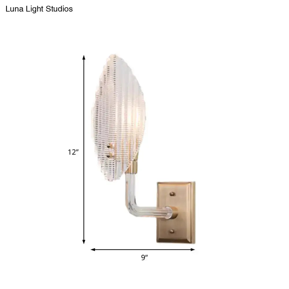 Contemporary brass leaf wall light fixture with clear glass shade and curved arm Decorbites on Tampa Home & Garden Store