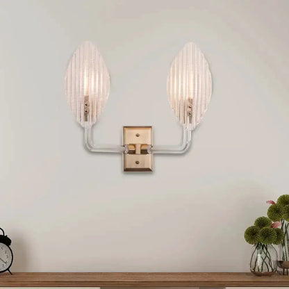 Contemporary brass leaf wall sconce with twin ribbed glass shades by Decorbites on Tampa Home & Garden Store