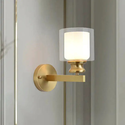 Contemporary brass wall light with frosted glass shade and wall-mount arm on Tampa Home & Garden Store