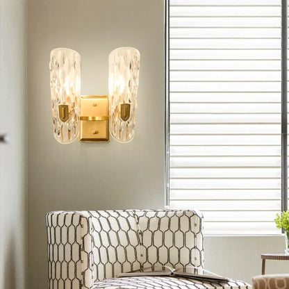 Decorbites brass water glass wall sconce with crystal glass shades and gold backplate on Tampa Home & Garden Store