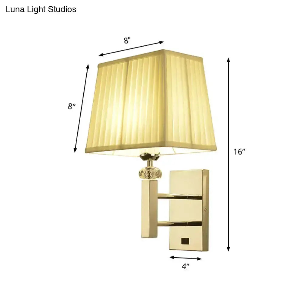 Contemporary brass wall sconce with beige fabric shade, 16in tall, 8in shade, 4in mount on Tampa Home & Garden Store