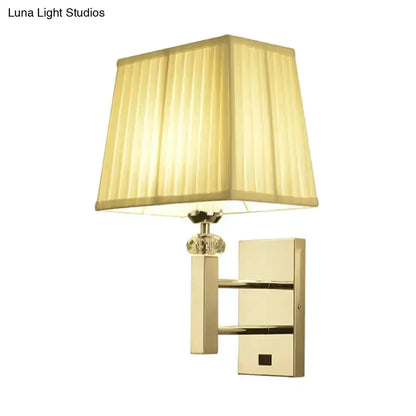 Contemporary brass wall sconce with beige pleated fabric shade and crystal accent on Tampa Home & Garden Store