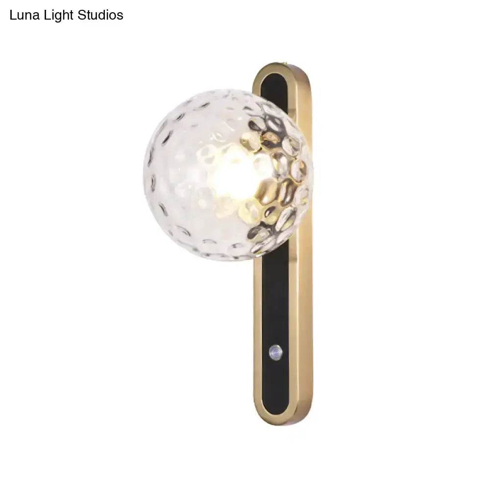 Decorbites contemporary clear glass wall sconce with hammered glass globe and brass-gold backplate on Tampa Home & Garden Store