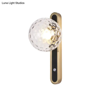 Decorbites contemporary clear glass wall sconce with hammered glass globe and brass-gold backplate on Tampa Home & Garden Store