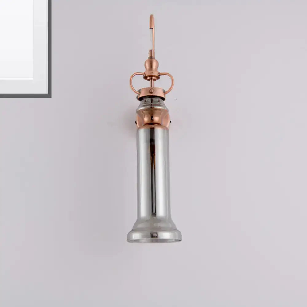 Copper amber glass sconce with copper hardware and cylindrical shade hanging from ceiling on Tampa Home & Garden Store
