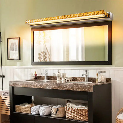 Contemporary crystal gold wall sconce with warm white LED above bathroom mirror Decorbites on Tampa Home & Garden Store