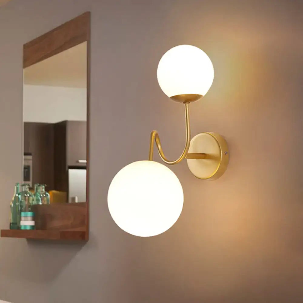 Gold glass wall sconce with dual adjustable frosted glass globes in brass finish on Tampa Home & Garden Store