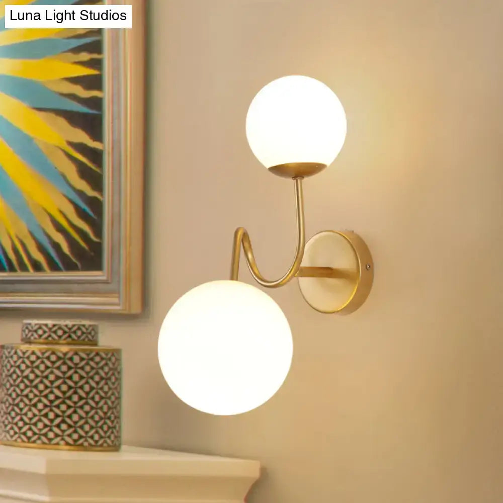 Gold glass wall sconce with dual adjustable heads in brass finish by Decorbites on Tampa Home & Garden Store