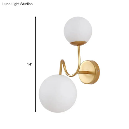 Gold glass wall sconce with two adjustable heads and two white glass globes by Decorbites on Tampa Home & Garden Store