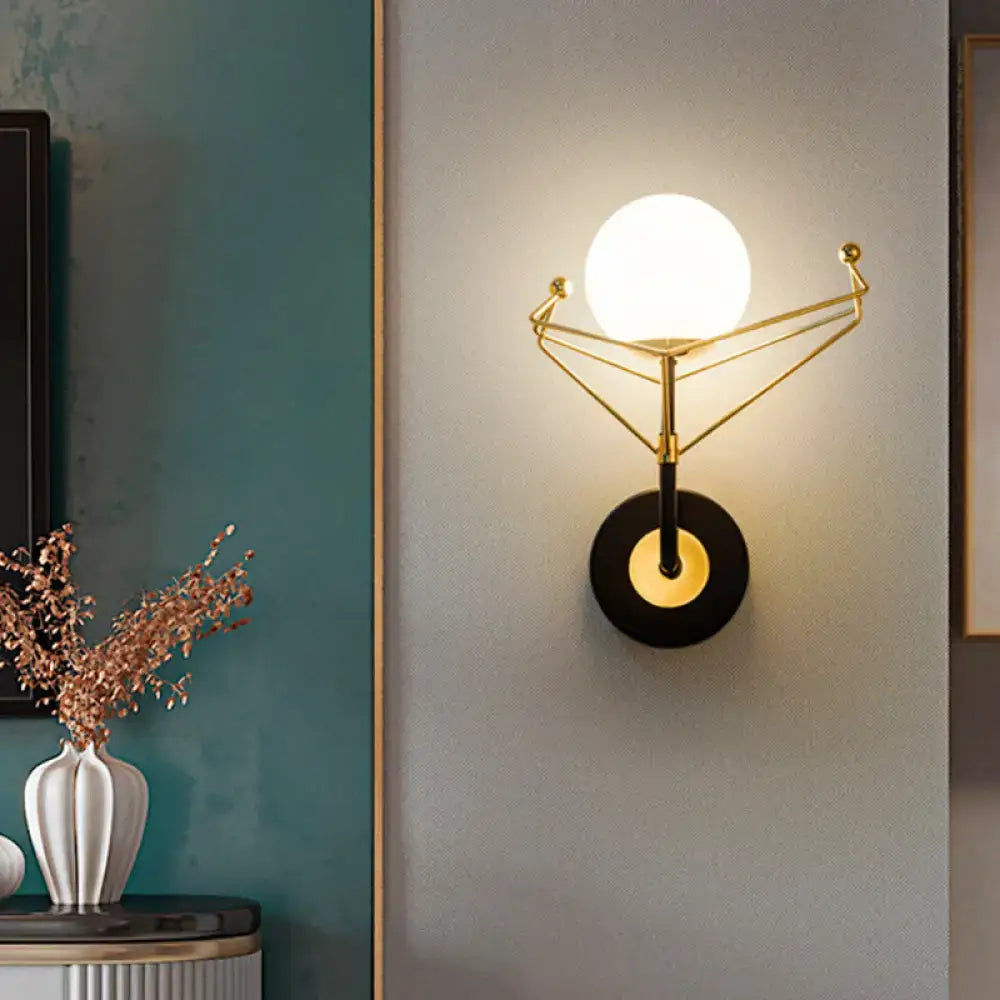 Gold Glass Orb Sconce by Decorbites with white glass orb and gold geometric frame on wall on Tampa Home & Garden Store