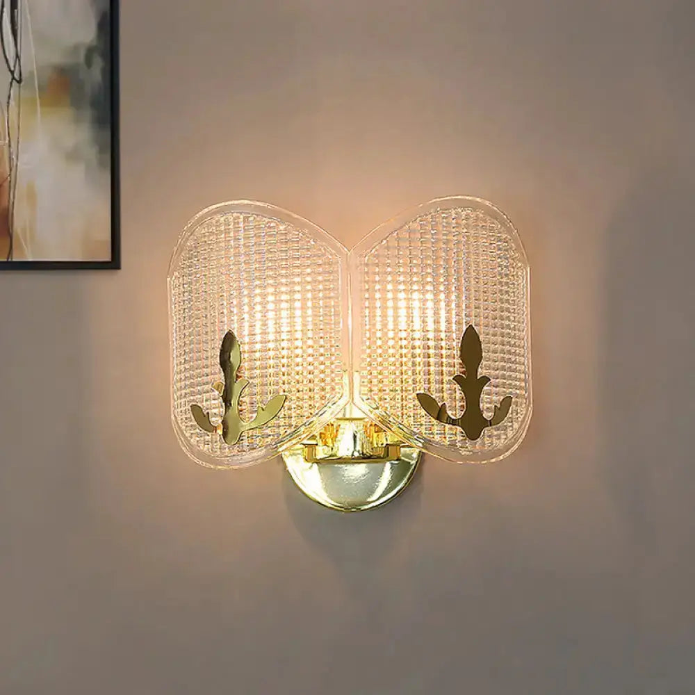 Contemporary gold arc light fixture wall sconce with dual glass panels and brass leaf accents on Tampa Home & Garden Store