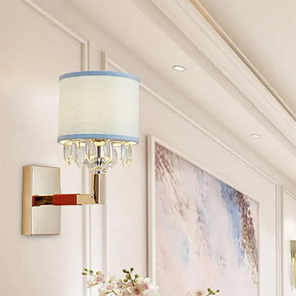 Gold crystal fabric shade sconce with blue trim and hanging prisms on wall mount on Tampa Home & Garden Store