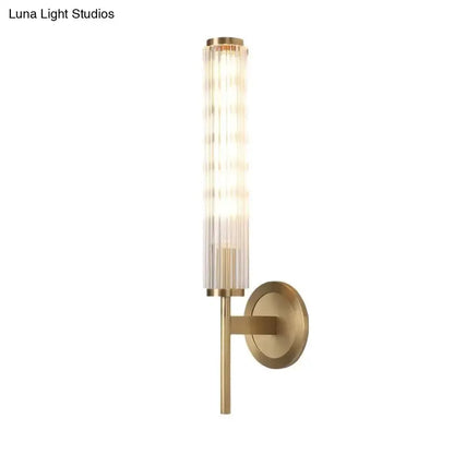 Decorbites gold brass cylinder wall sconce with glass tube and round backplate on Tampa Home & Garden Store