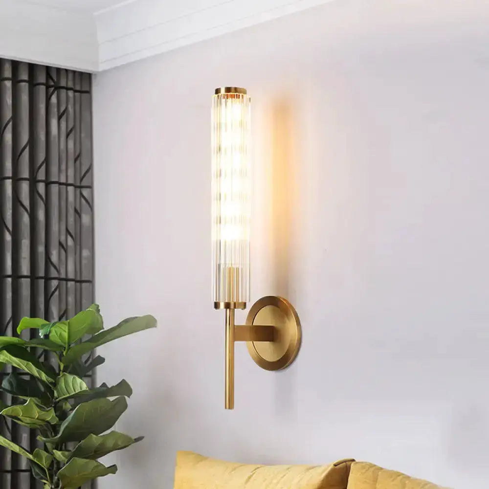 Contemporary gold brass cylinder wall light sconce by Decorbites, ribbed glass tube glow on Tampa Home & Garden Store