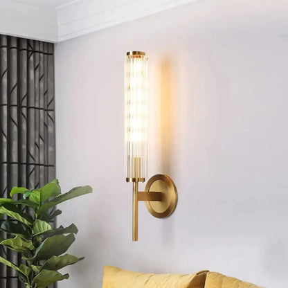Contemporary gold brass cylinder wall light sconce by Decorbites, ribbed glass tube glow on Tampa Home & Garden Store