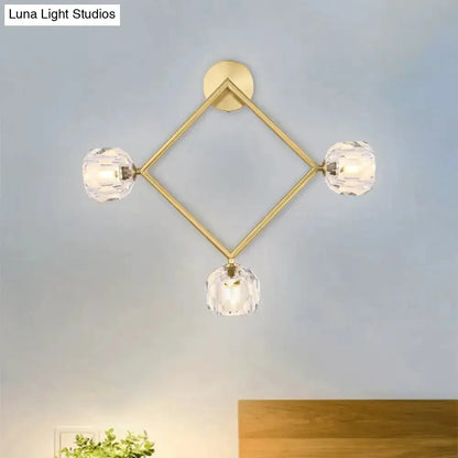 Contemporary gold brass wall light fixture with diamond frame and four crystal prisms on Tampa Home & Garden Store