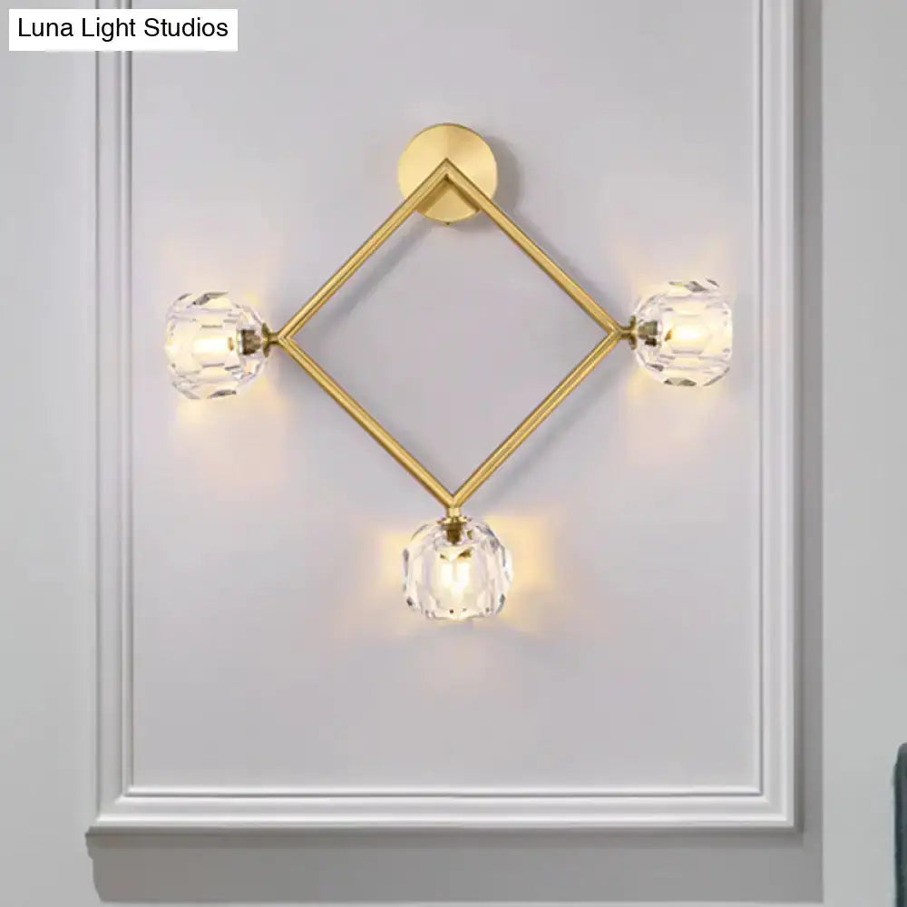 Contemporary gold brass wall light fixture with three crystal globe sconces in a diamond frame on Tampa Home & Garden Store