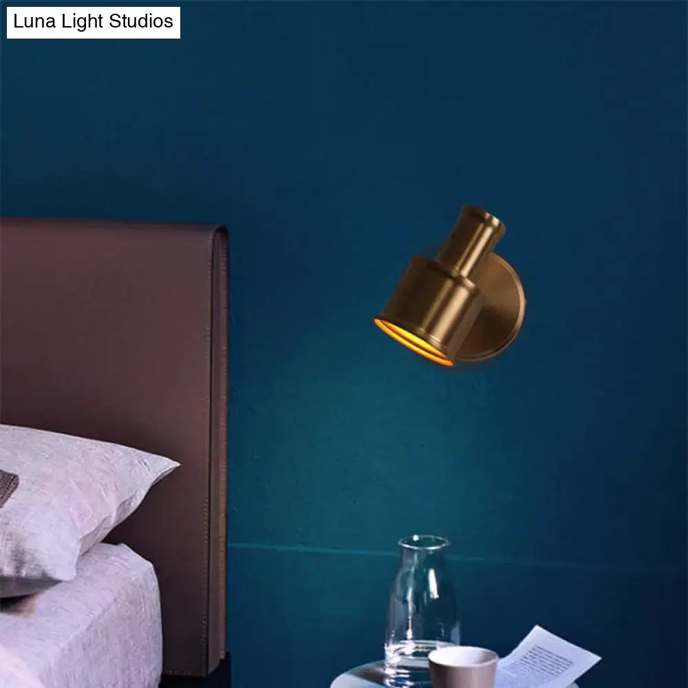 Gold Cylinder Wall Sconce by Decorbites with brass finish mounted on blue bedroom wall on Tampa Home & Garden Store