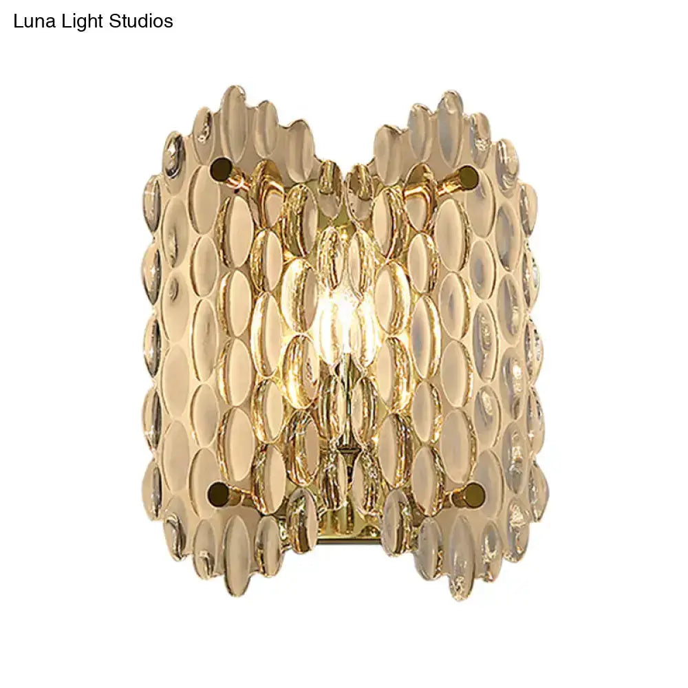 Decorbites contemporary gold metal wall sconce with clear crystal discs in a scalloped pattern on Tampa Home & Garden Store