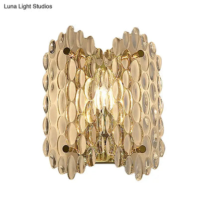 Decorbites contemporary gold metal wall sconce with clear crystal discs in a scalloped pattern on Tampa Home & Garden Store
