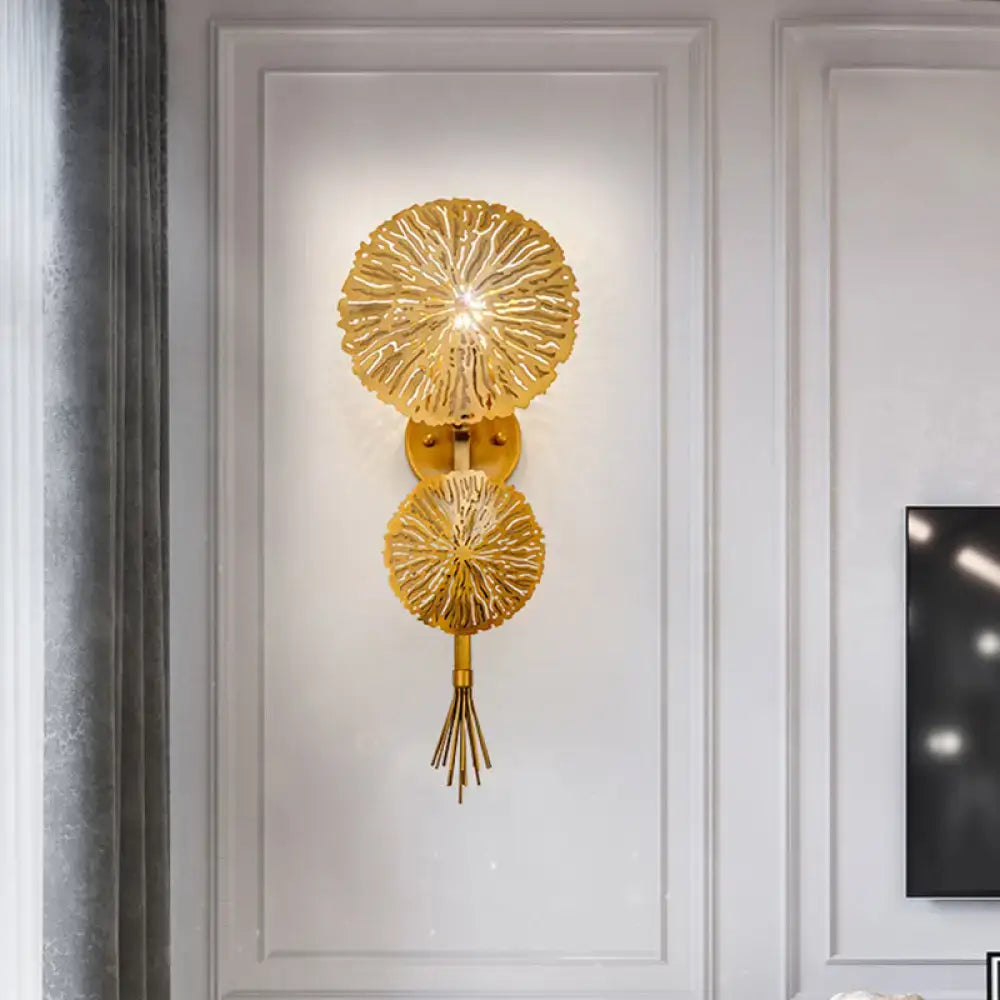 Gold sunburst wall sconce with two radial discs and tassel, wall mounted on Tampa Home & Garden Store