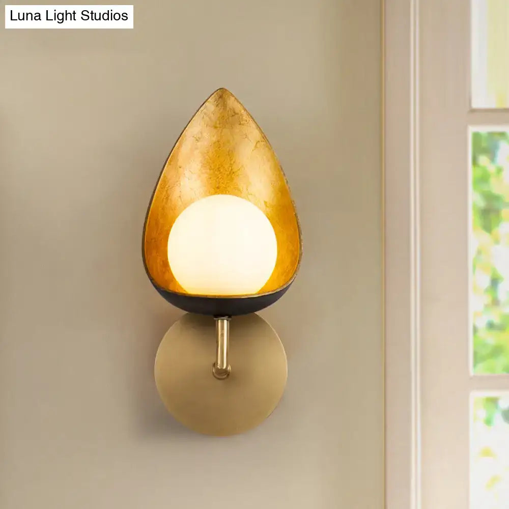Decorbites Gold Teardrop Glass Sconce with warm glowing globe and brass wall mount on Tampa Home & Garden Store