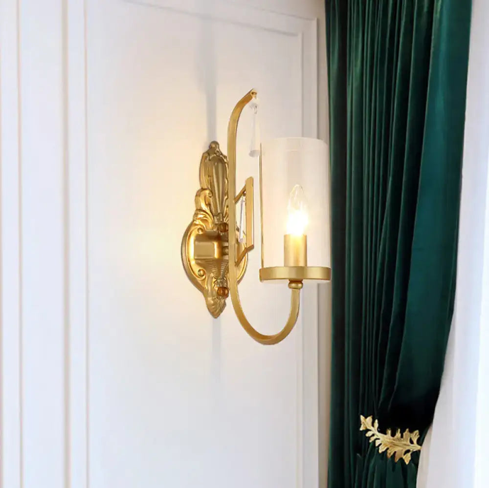 Gold clear glass sconce with curved arm and ornate backplate, 1-light Decorbites on Tampa Home & Garden Store