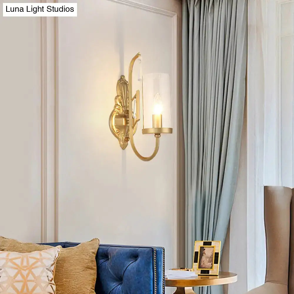 Gold clear glass sconce with ornate backplate and curved arm, 1-2 light design on Tampa Home & Garden Store