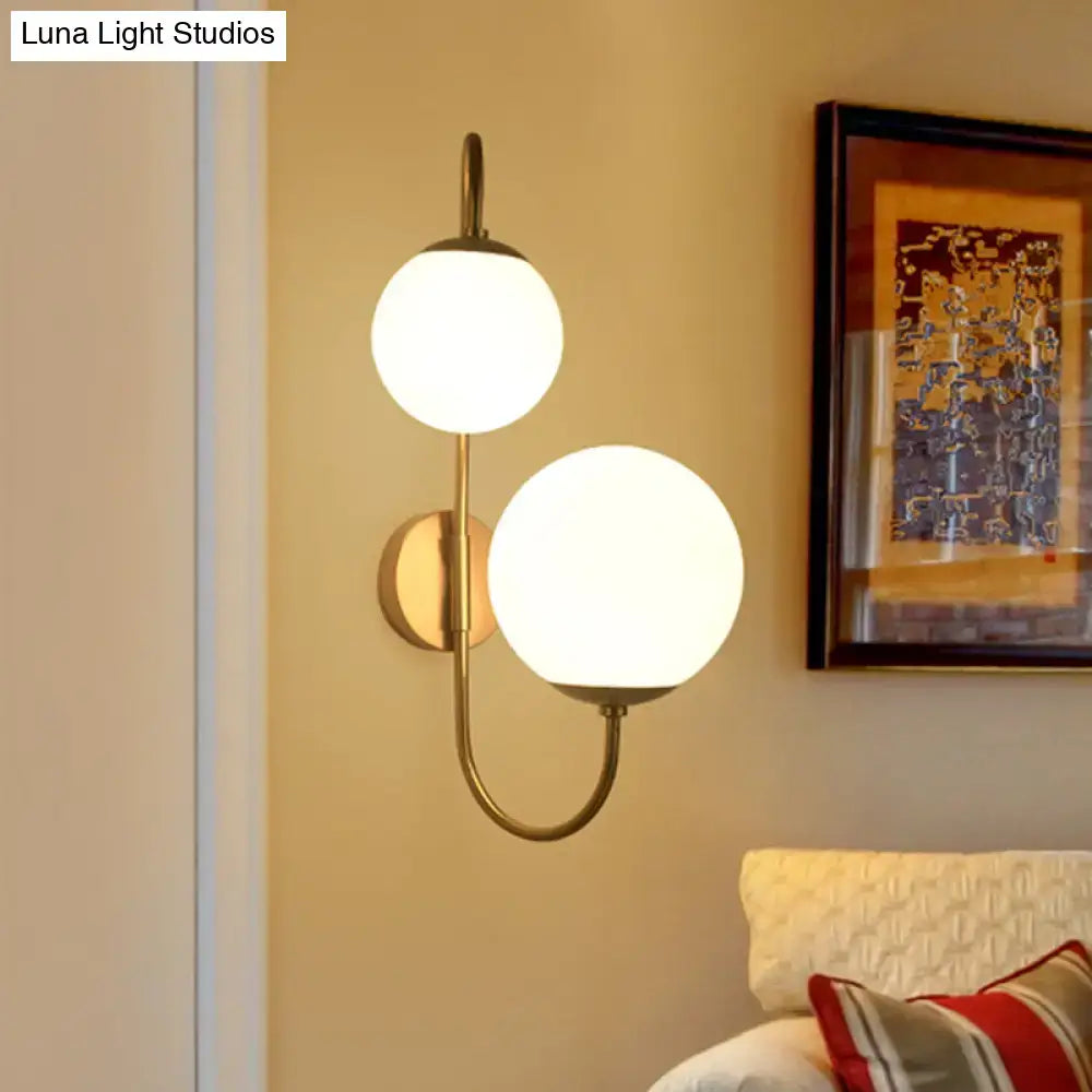 Gold Opal Glass Ball Shade Dual-Arm Sconce wall-mounted brass finish with two globe shades Decorbites on Tampa Home & Garden Store