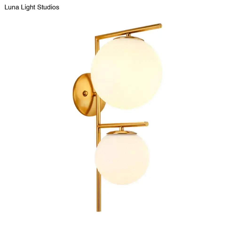 Contemporary gold & white glass dual-globe wall sconce with brass frame on Tampa Home & Garden Store