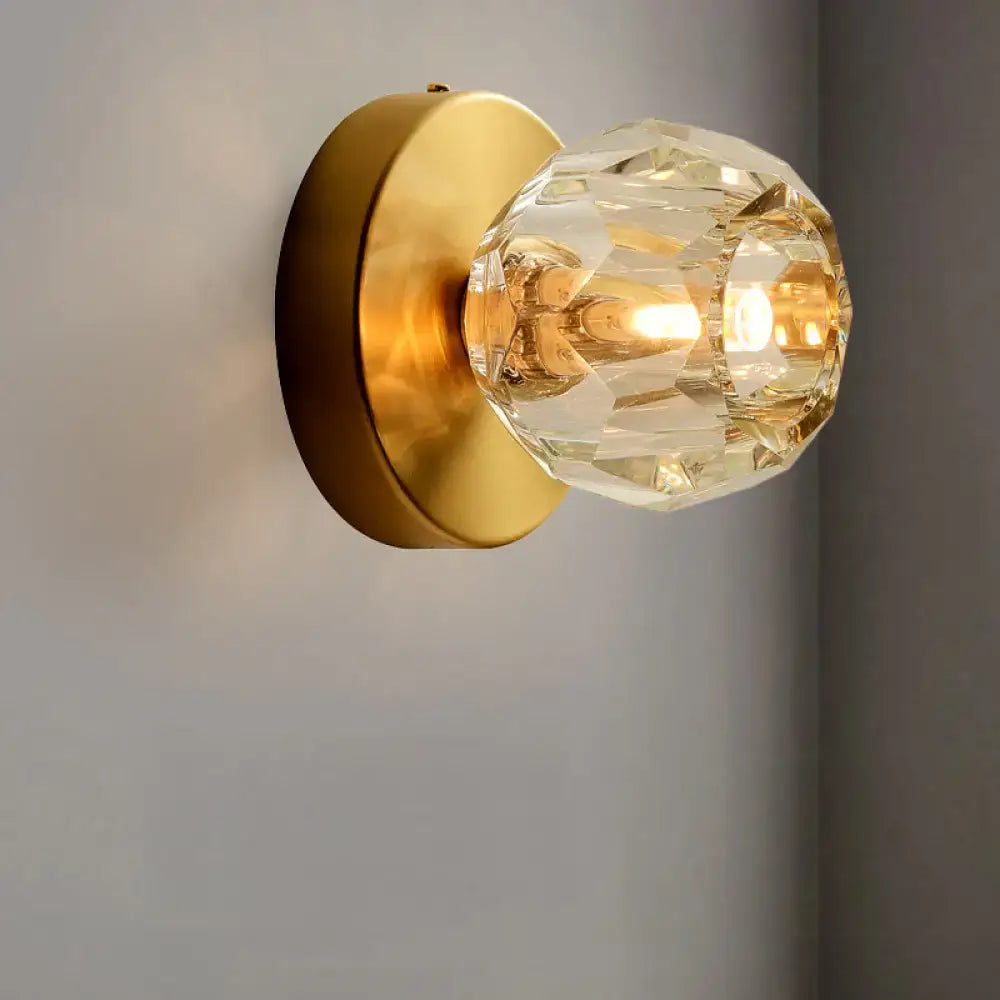 Gold faceted wall lamp with clear crystal bulb cover and brass backplate on Tampa Home & Garden Store