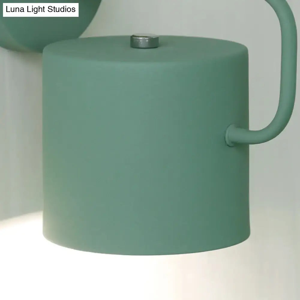 Gray metal wall sconce with matte green cylindrical shade and curved arm Decorbites on Tampa Home & Garden Store