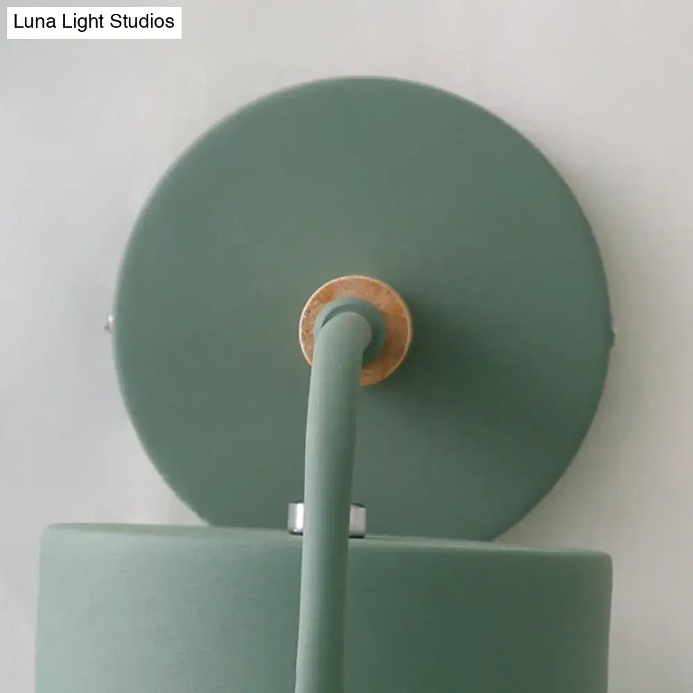 Gray metal wall sconce with round backplate and curved arm by Decorbites on Tampa Home & Garden Store