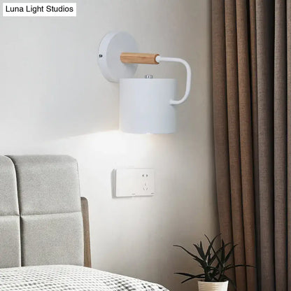 Gray Metal Wall Sconce Decorbites with white cylindrical shade and wood accent on wall on Tampa Home & Garden Store