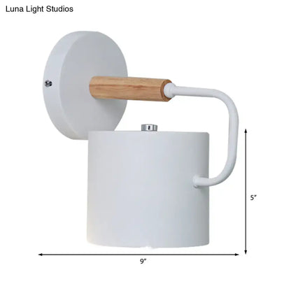 Gray metal wall sconce with cylindrical shade and wood-accent arm Decorbites on Tampa Home & Garden Store