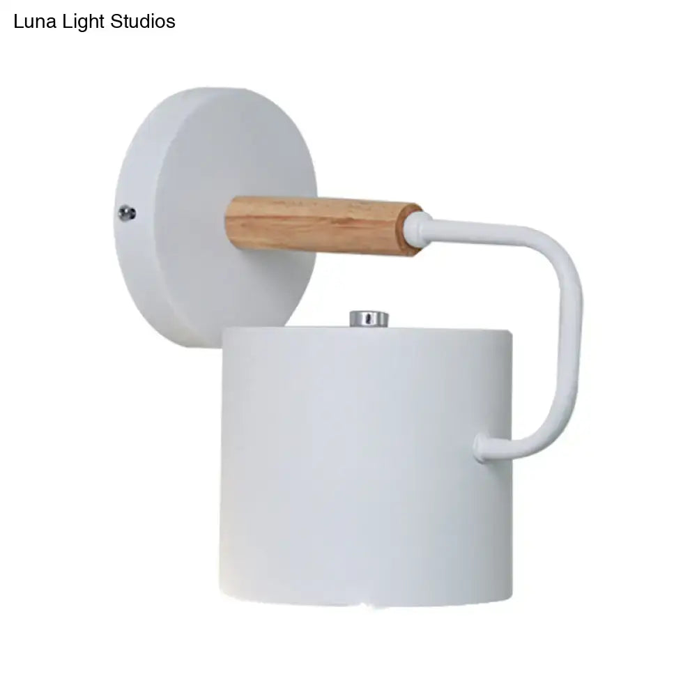 Gray metal wall sconce with white cylindrical shade and wood accent by Decorbites on Tampa Home & Garden Store