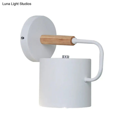 Gray metal wall sconce with white cylindrical shade and wood accent by Decorbites on Tampa Home & Garden Store